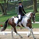 A woman riding on the back of a horse.